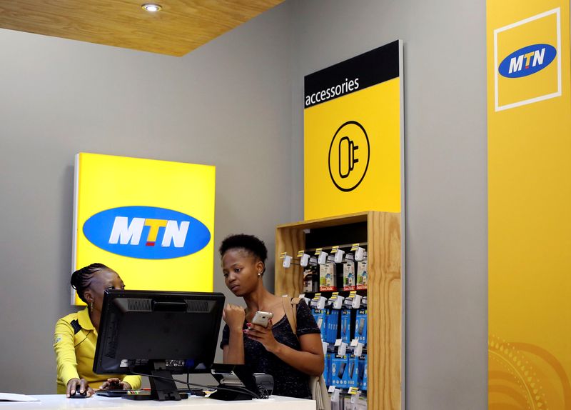 &copy; Reuters. FILE PHOTO: A worker attends to a customer at an MTN shop at a mall in Johannesburg, South Africa, March 2, 2017. REUTERS/Siphiwe Sibeko