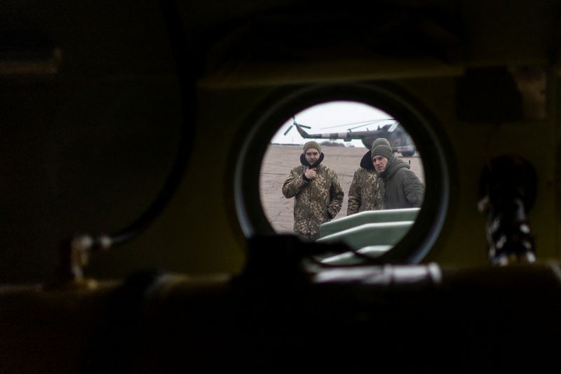 &copy; Reuters. Service members of the Ukrainian armed forces are seen from inside of an helicopter window at an airfield near Kramatorsk in the Donetsk region, Ukraine February 17, 2022. REUTERS/Carlos Barria