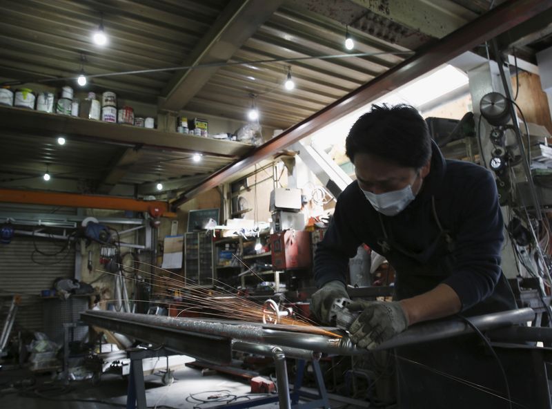&copy; Reuters. FILE PHOTO: An engineer makes an arm rail for residential buildings inside a metal processing factory at an industrial zone in downtown Tokyo, Japan, March 22, 2016. REUTERS/Yuya Shino