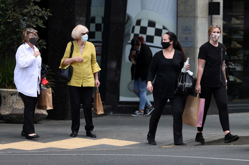 &copy; Reuters. FILE PHOTO: Shoppers walk through a retail district in the wake of coronavirus disease (COVID-19) lockdown restrictions being eased in Auckland, New Zealand, November 10, 2021.  REUTERS/Fiona Goodall