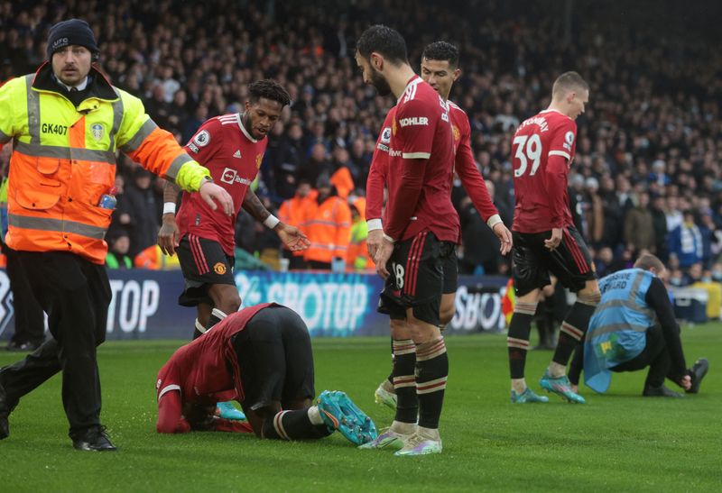 &copy; Reuters. Soccer Football - Premier League - Leeds United v Manchester United - Elland Road, Leeds, Britain - February 20, 2022 Manchester United's Anthony Elanga reacts after being struck in the head by an object as they celebrated their third goal scored by Fred 