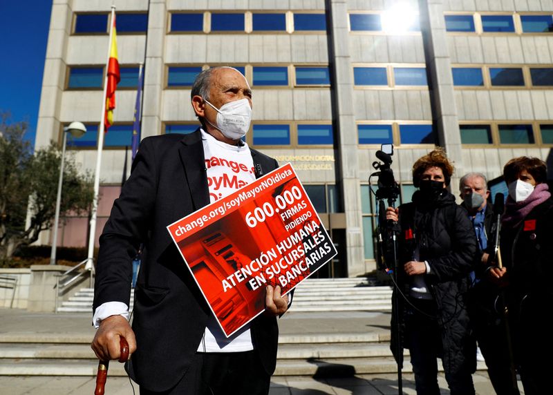 &copy; Reuters. FILE PHOTO: Retiree Carlos San Juan, creator of the "SoyMayorNoIdiota" ("I'm old, not an idiot") campaign, is photographed after registering 600,000 signatures against elderly exclusion by banks, at the Ministry of Economy, in Madrid, Spain, February 8, 2