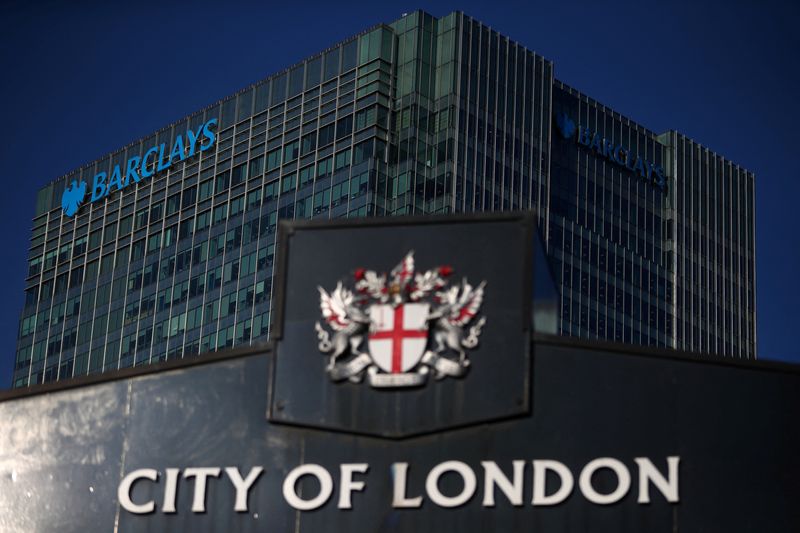 &copy; Reuters. FILE PHOTO: Barclays' building in Canary Wharf is seen behind a City of London sign outside Billingsgate Market in London, Britain, August 8, 2018. REUTERS/Hannah McKay