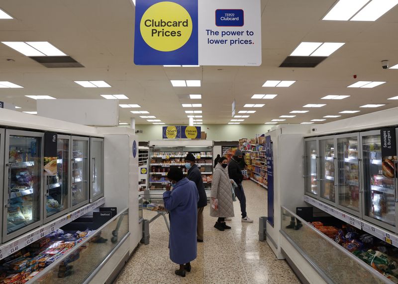 &copy; Reuters. Shoppers walk next to the clubcard branding inside a branch of a Tesco Extra Supermarket in London, Britain, February 10, 2022. Picture taken February 10, 2022. REUTERS/Paul Childs