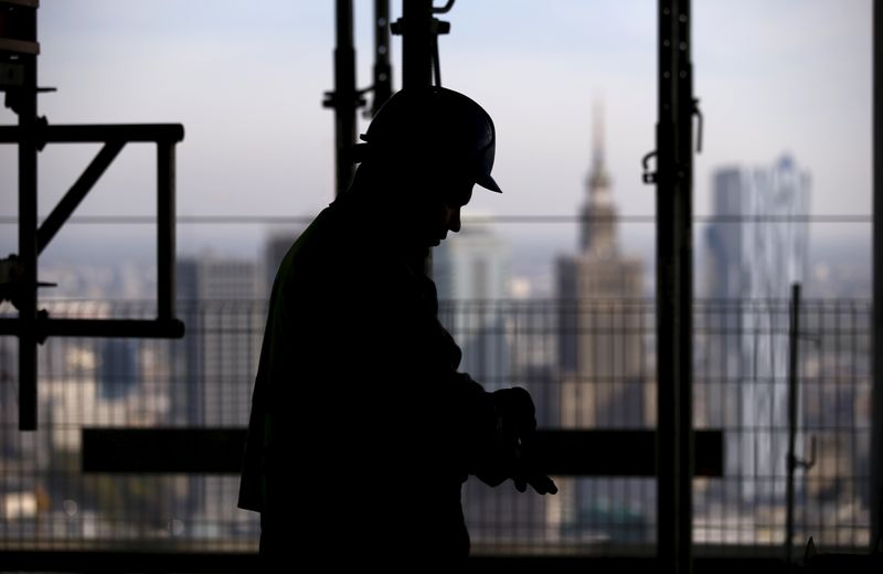 &copy; Reuters. FILE PHOTO: The Palace of Culture is seen behind a worker at the construction site of the new skyscraper in Warsaw, Poland October 2, 2015. REUTERS/Kacper Pempel