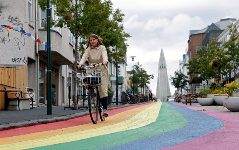 &copy; Reuters. A woman cycles down a street painted in rainbow colours near the Hallgrimskirkja church, as the outbreak of the coronavirus disease (COVID-19) continues, in Reykjavik, Iceland, September 3, 2020. REUTERS/John Sibley/Files