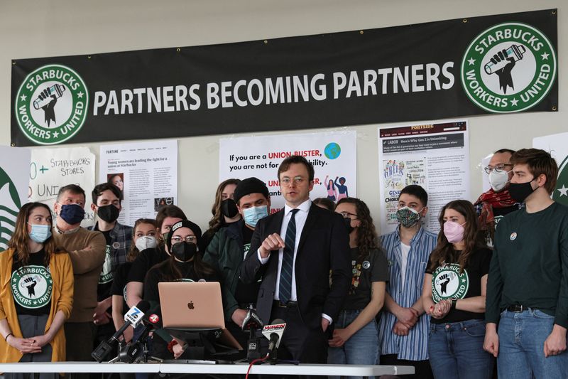 © Reuters. Attorney Ian Hayes and Starbucks workers speak during a news conference to react to a decision by the National Labor Relations Board to postpone a scheduled union vote count in Buffalo, New York, U.S., February 23, 2022. REUTERS/Brendan McDermid