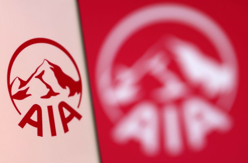 &copy; Reuters. FILE PHOTO: AIA Group logo is pictured on a smartphone in front of an electronic display showing the same logo in this illustration taken, December 4, 2021. REUTERS/Dado Ruvic/Illustration