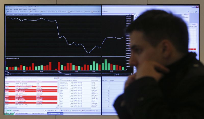 &copy; Reuters. FILE PHOTO: A man walks past an information screen on display inside the office of the Moscow Exchange in the capital Moscow March 14, 2014. REUTERS/Maxim Shemetov 