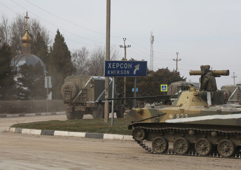 &copy; Reuters. Military vehicles drive along a street, after Russian President Vladimir Putin authorized a military operation in eastern Ukraine, in the town of Armyansk, Crimea, February 24, 2022. REUTERS/Stringer
