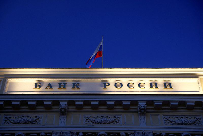 &copy; Reuters. FILE PHOTO: A Russian state flag flies over the Central Bank headquarters in Moscow, Russia March 29, 2021. A sign reads: "Bank of Russia". REUTERS/Maxim Shemetov//File Photo