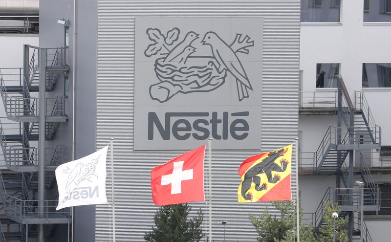 &copy; Reuters. FILE PHOTO: A Swiss national flag flies beside a flag of the canton of Bern in front of the logo of Nestle at a plant in Konolfingen, Switzerland September 28, 2020. REUTERS/Arnd Wiegmann