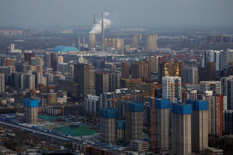 © Reuters. Residential buildings under construction and a power station are seen near the central business district (CBD) in Beijing, China, January 15, 2021.   REUTERS/Tingshu Wang