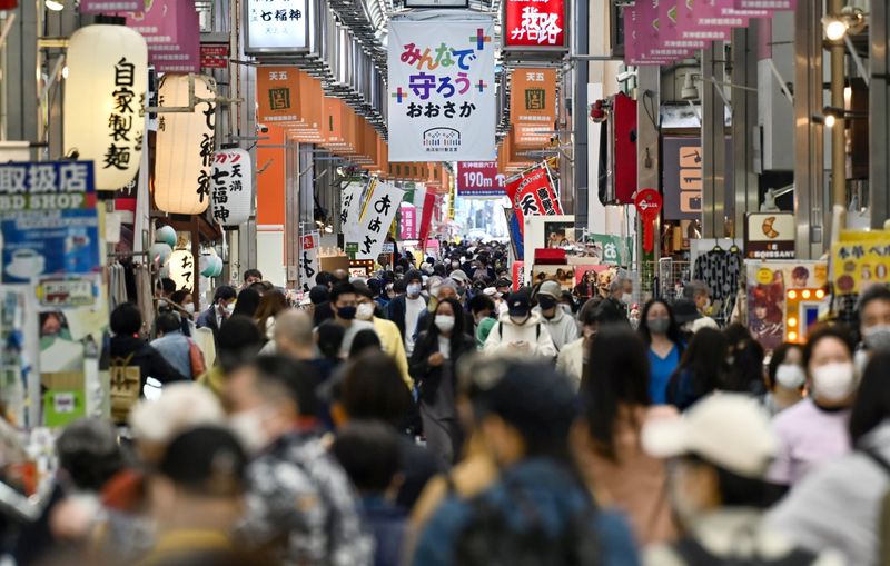 &copy; Reuters. Pedestrians wearing protective face masks, amid the coronavirus disease (COVID-19) pandemic, are seen at a shopping district in Osaka, Japan, in this photo taken by Kyodo April 7, 2021. Mandatory credit Kyodo/via REUTERS  