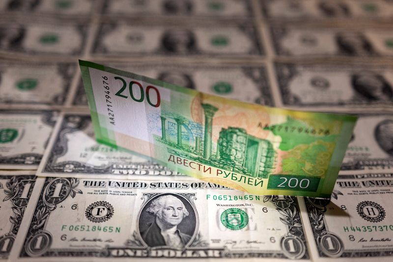 &copy; Reuters. Russian Rouble banknote is placed on U.S. Dollar banknotes in this illustration taken, February 24, 2022. REUTERS/Dado Ruvic/Illustration