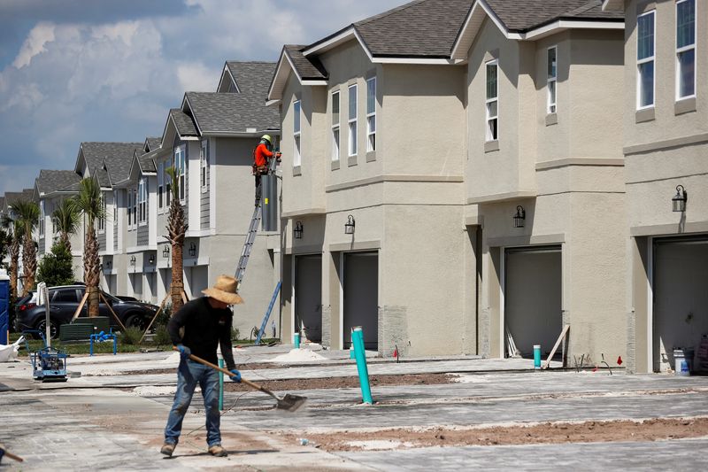 &copy; Reuters. FILE PHOTO - A carpenter works on building new townhomes that are still under construction while building material supplies are in high demand in Tampa, Florida, U.S., May 5, 2021.  REUTERS/Octavio Jones