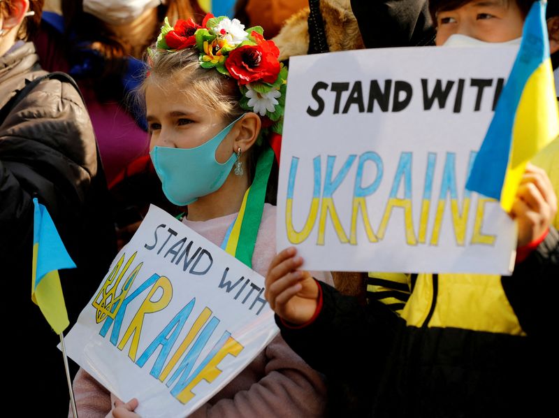 &copy; Reuters. Niños ucranianos sostienen pancartas durante una protesta contra la invasión de Rusia a Ucrania, en Tokio, Japón. 26 de febrero, 2022. REUTERS/Kim Kyung-Hoon