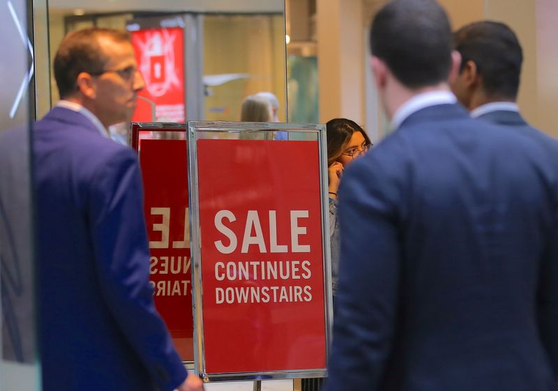 &copy; Reuters. FILE PHOTO: Shoppers walk through a shopping centre past a retail store displaying a sale sign in central Sydney, Australia, November 1, 2017. REUTERS/Steven Saphore