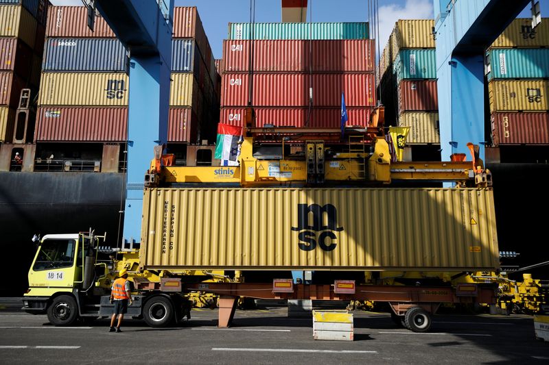 &copy; Reuters. FILE PHOTO: Containers carrying goods from the United Arab Emirates, which entered Israel on an MSC cargo ship, are unloaded with a cargo crane bearing Israeli and Emirati flags at Haifa's port, northern Israel  October 12, 2020. REUTERS/Amir Cohen