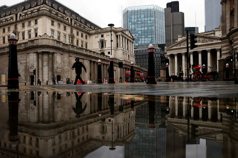 &copy; Reuters. FILE PHOTO: The Bank of England and Royal Exchange are reflected in a puddle as a pedestrian walks past, amid the coronavirus disease (COVID-19) outbreak in London, Britain, November 19, 2020. REUTERS/Simon Dawson