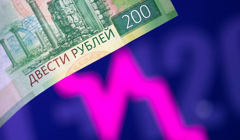 &copy; Reuters. FILE PHOTO: A Russian rouble banknote is seen in front of a descending stock graph in this illustration taken March 1, 2022. REUTERS/Dado Ruvic/Illustration