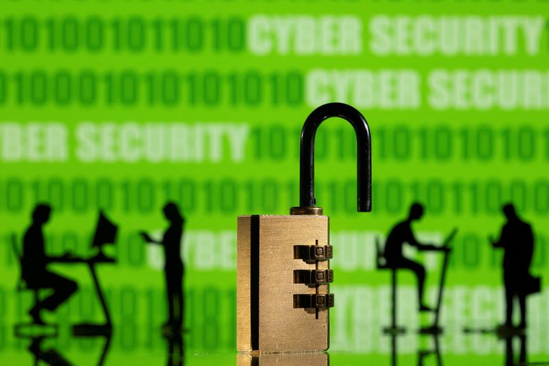 © Reuters. FILE PHOTO: 3D printed models of people working on computers and padlock are seen in front of a displayed CYBER SECURITY words and binary code in this picture illustration taken, February 1, 2022. REUTERS/Dado Ruvic/Illustration