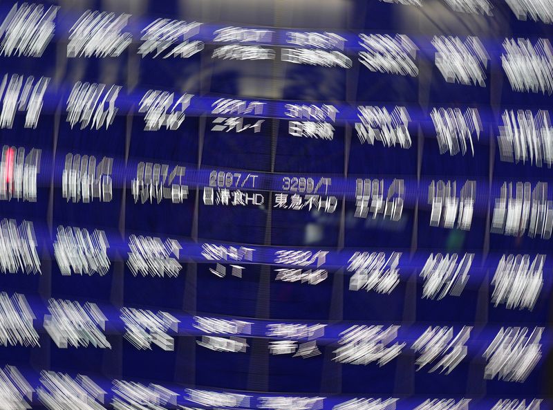 &copy; Reuters. A screen displays blank prices on a stock quotation board after Tokyo Stock Exchange temporarily suspended all trading due to system problems, outside a brokerage, amid the COVID-19 pandemic, in Tokyo, Japan October 1, 2020. Picture taken with a slow shut