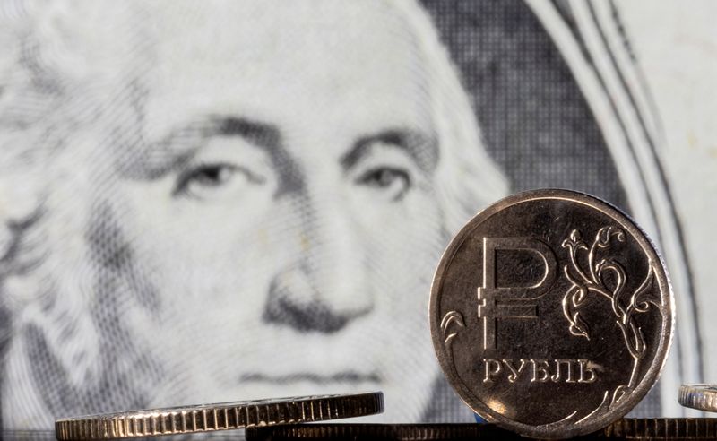 &copy; Reuters. Russian Rouble coins are seen in front of displayed U.S. Dollar banknote in this illustration taken, February 24, 2022. REUTERS/Dado Ruvic/Illustration/Files