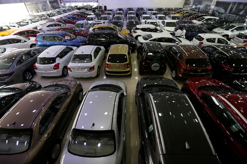 &copy; Reuters. FILE PHOTO: Auto dealers stand between the cars displayed for sale at a second hand car showroom Shoneez Motors in Sanabis, west of Manama, Bahrain, April 10, 2019. REUTERS/ Hamad I Mohammed/File Photo