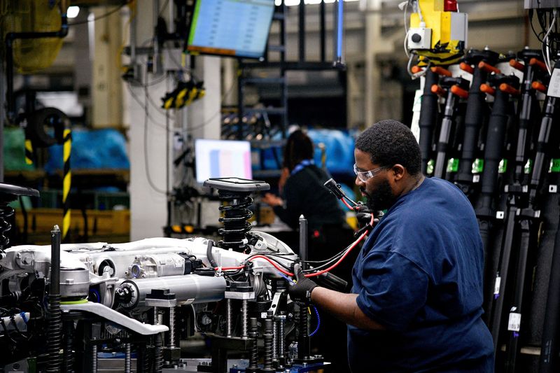 &copy; Reuters. FILE PHOTO: A worker attaches a wiring harness to the chassis of an X model SUV at the BMW manufacturing facility in Greer, South Carolina, U.S. November 4, 2019.  REUTERS/Charles Mostoller