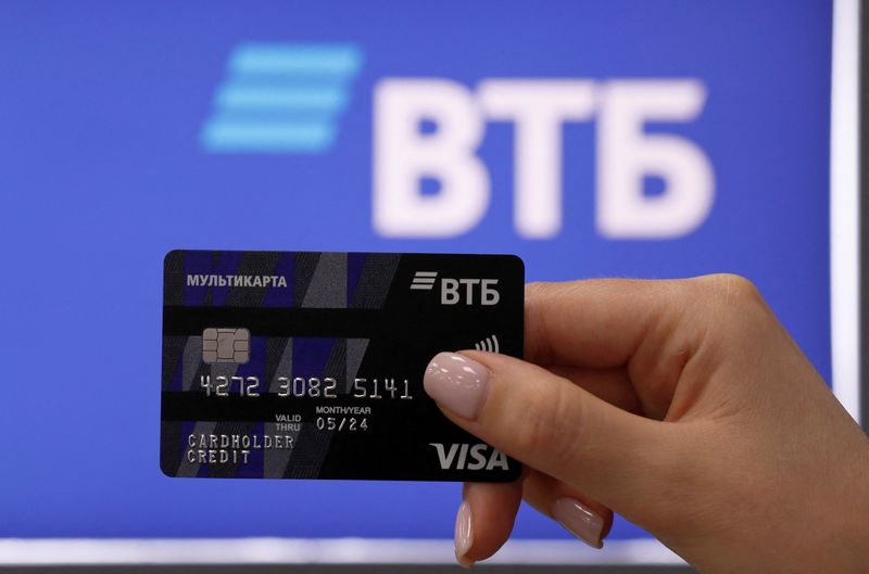 &copy; Reuters. FILE PHOTO: An employee poses for a picture while demonstrating a payment card at a branch of VTB bank in Moscow, Russia May 30, 2019. REUTERS/Evgenia Novozhenina/File Photo