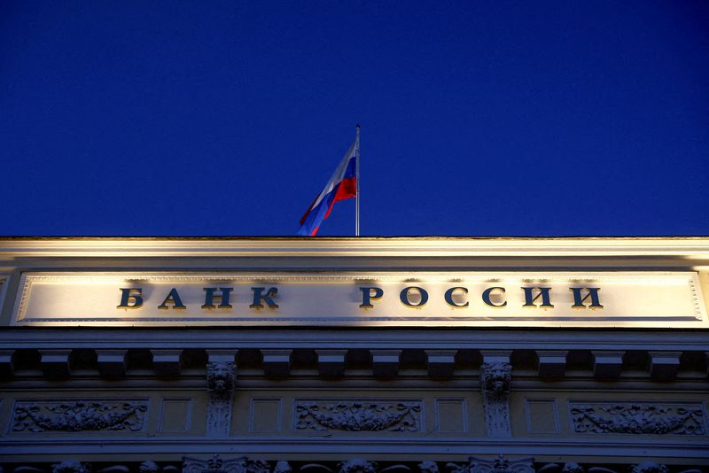 &copy; Reuters. FILE PHOTO: A Russian state flag flies over the Central Bank headquarters in Moscow, Russia March 29, 2021. A sign reads: "Bank of Russia". REUTERS/Maxim Shemetov