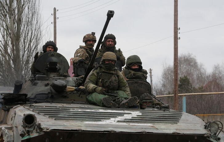 &copy; Reuters. Service members of pro-Russian troops in uniforms without insignia are seen atop of an armoured vehicle with the letter "Z" painted on its front in the separatist-controlled settlement of Buhas (Bugas), as Russia's invasion of Ukraine continues, in the Do