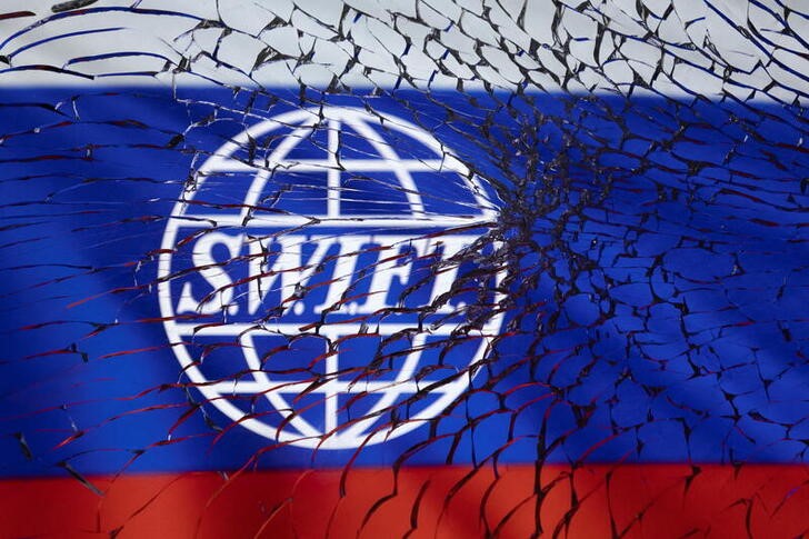 &copy; Reuters. SWIFT logo and Russian flag are seen through broken glass in this illustration taken March 1, 2022. REUTERS/Dado Ruvic/Illustration