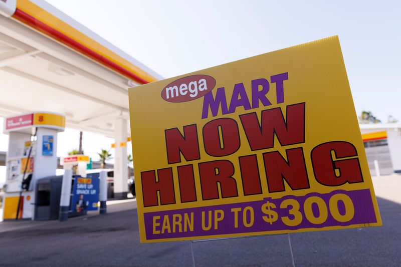 © Reuters. A job posting looking for workers is shown at a gas station in San Diego, California, U.S. November, 9, 2021.  REUTERS/Mike Blake