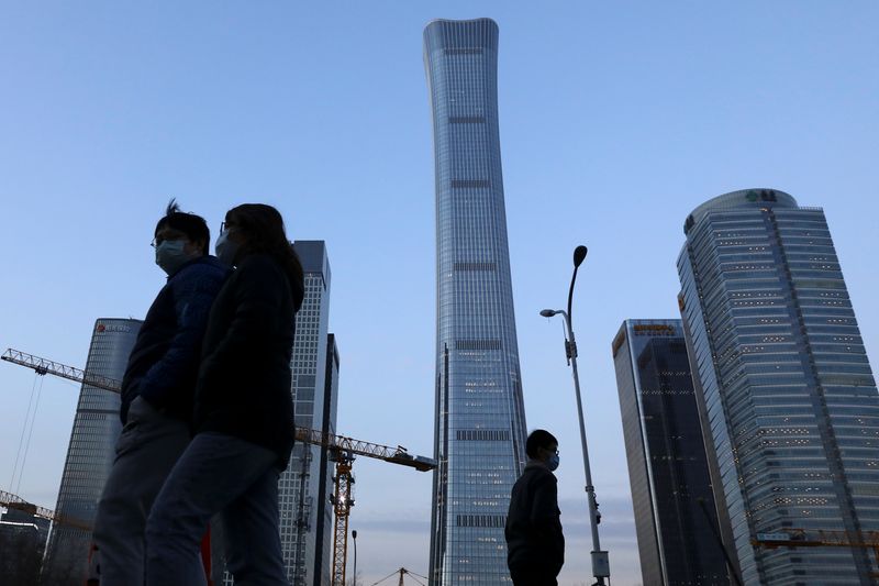 &copy; Reuters. FILE PHOTO: People walk past the Central Business District (CBD) in Beijing, China January 16, 2022. Picture taken January 16, 2022. REUTERS/Tingshu Wang