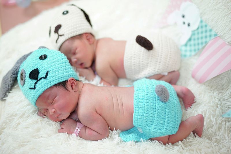 &copy; Reuters. FILE PHOTO: Newborn babies wearing dog costumes to celebrate the New Year of the Dog are pictured at the nursery room of Paolo Chokchai 4 Hospital in Bangkok, Thailand, December 28, 2017. REUTERS/Athit Perawongmetha