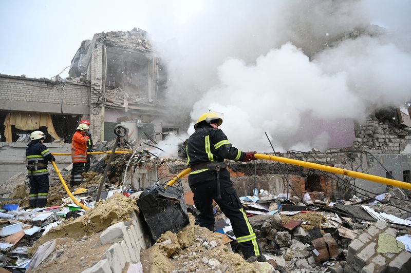 &copy; Reuters. رجال الإطفاء في موقع مبنى مدرسة تعرض للقصف في إحدى مدن أوكرانيا يوم 4 مارس آذار 2022. رويترز