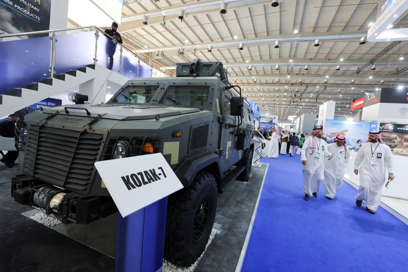 &copy; Reuters. FILE PHOTO: Saudi men are seen walking in front of Ukrainian stand displaying the latest defense system at World Defense Show in Riyadh, Saudi Arabia, March 6, 2022. REUTERS/Ahmed Yosri