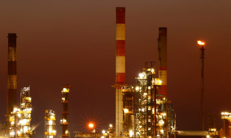 © Reuters. The chimneys of the Total Grandpuits oil refinery are seen just after sunset, southeast of Paris, France, March 1, 2021.  REUTERS/Christian Hartmann