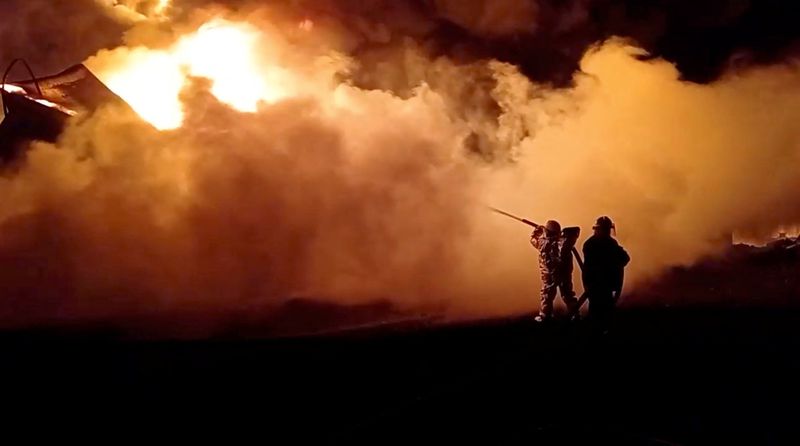 &copy; Reuters. Fire fighters extinguish fire in an oil depot that Ukraine's State Emergency Services say was caused by Russian strikes in Zhytomyr region, Ukraine March 7, 2022 in this still image obtained from a handout video. State Emergency Services of Ukraine/Handou