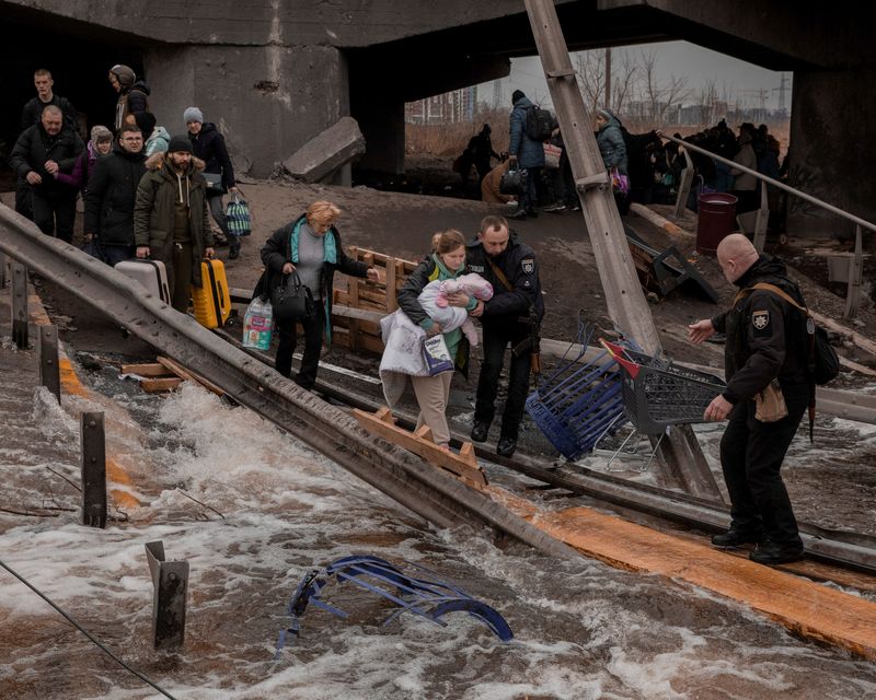 &copy; Reuters. Local residents cross a destroyed bridge as they evacuate from their town in Irpin, near Kyiv, Ukraine March 7, 2022. Jedrzej Nowicki/Agencja Wyborcza.pl via REUTERS