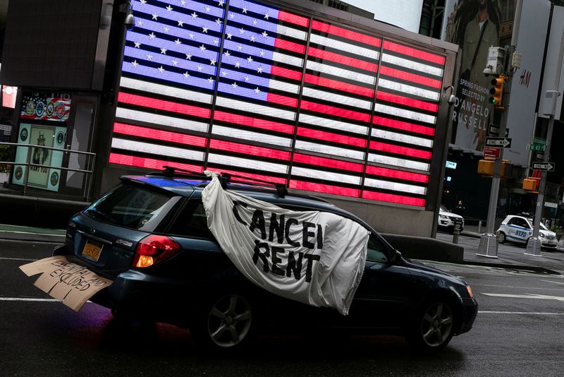 &copy; Reuters. FILE PHOTO: A sign is displayed on a car in Times Square during a demonstration calling for workers' rights and cancelling of rent payment as the spread of the coronavirus disease (COVID-19) continues in New York City, New York, U.S., May 1, 2020. REUTERS