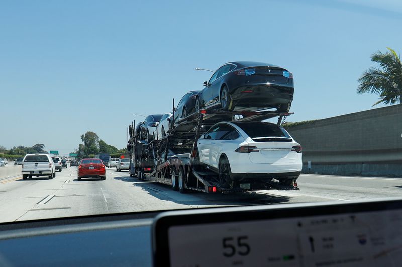 &copy; Reuters. FILE PHOTO: Newly built Tesla electric vehicles are transported for delivery along a highway in Los Angeles, California, U.S., June 27, 2019.   REUTERS/Mike Blake