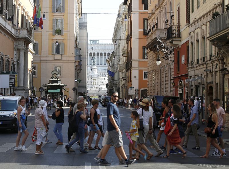 &copy; Reuters. FILE PHOTO: People cross the street in Rome Italy, August 29, 2019.  REUTERS/Ciro De Luca