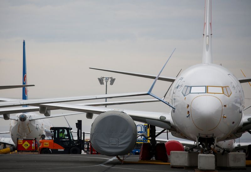 &copy; Reuters. A worker in a forklift drives by grounded Boeing 737 MAX aircraft at Grant County International Airport in Moses Lake, Washington, U.S. November 17, 2020.  REUTERS/Lindsey Wasson