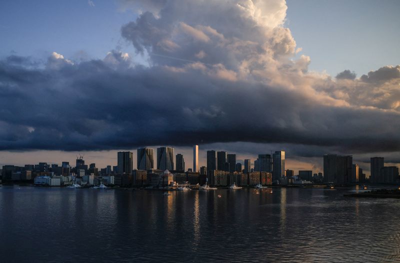 &copy; Reuters. FILE PHOTO: City skyline and harbour are seen at sunrise from a quarantine bus window during the Tokyo 2020 Olympic Games in Tokyo, Japan July 24, 2021. REUTERS/Maxim Shemetov