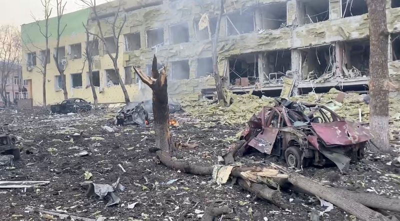 © Reuters. Debris is seen on site of the destroyed Mariupol children's hospital as Russia's invasion of Ukraine continues, in Mariupol, Ukraine, March 9, 2022 in this still image from a handout video obtained by Reuters. Ukraine Military/Handout via REUTERS    