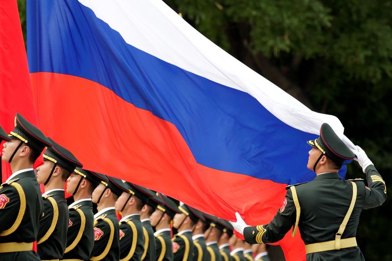 &copy; Reuters. FILE PHOTO: An honour guard holds a Russia flag during preparations for a welcome ceremony for Russian President Vladimir Putin outside the Great Hall of the People in Beijing, China June 8, 2018. REUTERS/Jason Lee