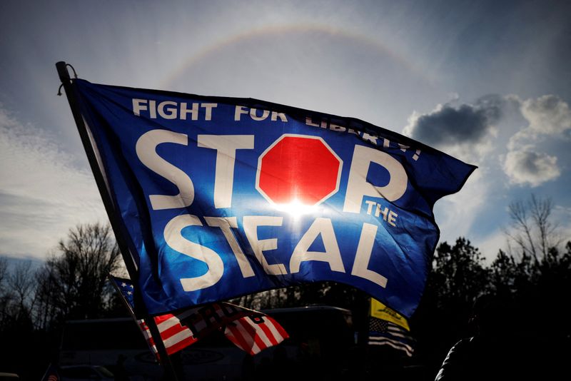 &copy; Reuters. FILE PHOTO: A "Stop the Steal" flag flies outside a campaign rally with U.S. President Donald Trump and Republican U.S. Senator Kelly Loeffler on the eve of Georgia’s run-off election in Dalton, Georgia, U.S., January 4, 2021.   REUTERS/Brian Snyder/Fil